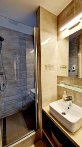 a bathroom with a sink and a shower at Hotel Kristína in Dubnica nad Váhom