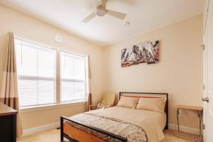 a bedroom with a bed and a ceiling fan at Capital Courts End unit My Luxe. in Upper Marlboro