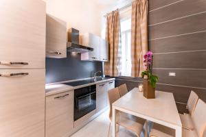 a kitchen with a table and chairs and a sink and a stove at Residenza Manin Apartments in Venice +34 photos