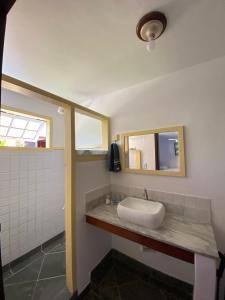 a bathroom with a sink and a mirror at Casa Sal in Paraty