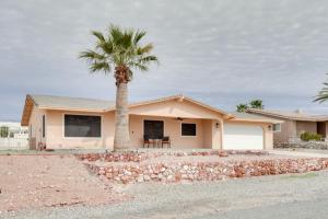 a palm tree in front of a house at Lake Havasu Home with Private Patio and Views! in Lake Havasu City