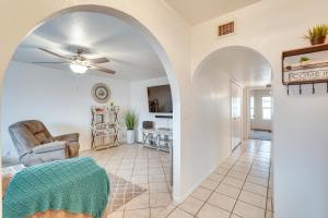a living room with a ceiling fan and an archway at Lake Havasu Home with Private Patio and Views! in Lake Havasu City
