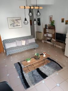 a living room with a couch and a coffee table at Sofia-Marina Guest House in Xanthi