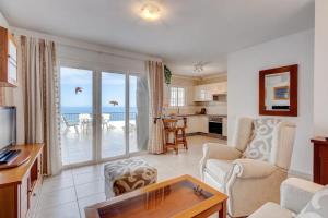 a living room with a view of the ocean at Los Gigantes Sea View in Santiago del Teide