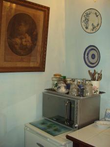 a kitchen with a microwave and a table with plates at La Cordière in Lourmarin