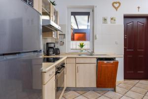 a kitchen with a sink and a stove top oven at Apartment with Veranda Toruńska Pobierowo by Renters in Pobierowo