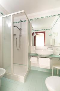 a bathroom with a shower and a sink at Hotel Imperia in Lido di Jesolo +44 photos