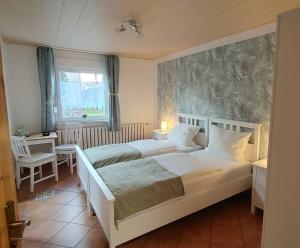 a bedroom with two beds and a window at Pension ZUM LINDENWALD Colbitz in Kolbitz