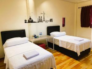 Cette chambre comprend 2 lits et un bureau. dans l'établissement IVI Hotel, à Jakarta
