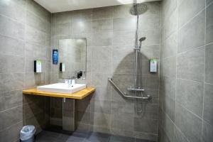 a bathroom with a sink and a shower at KYRIAD BORDEAUX SUD - Villenave d'Ornon in Villenave-dʼOrnon +54 photos