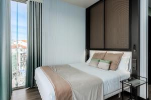 a bedroom with a large bed with a large window at Akeah Hotel Gran Vía in Madrid