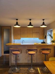 a kitchen with a counter and stools in it at The Milltown Apartment in Dublin