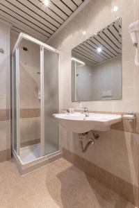 a bathroom with a sink and a shower at Hotel Relax in Siracusa