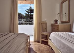 a bedroom with a bed and a view of a balcony at Windmill Hotel in Argasi +19 photos