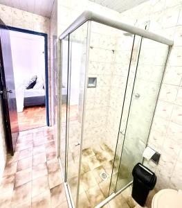 a shower with a glass door in a bathroom at Casa charmosa no Centro Histórico com garagem in Ouro Preto +29 photos