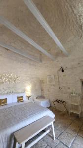 a bedroom with a bed in a stone wall at Casa Relax Isabelle in Alberobello