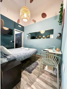 a bedroom with a bed and a table and a chair at Kofler GuestHouse in Barletta