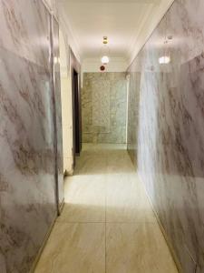 a hallway with marble walls and a walkway at Arabesque Hotel in Amman
