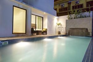 a swimming pool in the middle of a house at Chhouy Vathna Angkor Boutique in Siem Reap