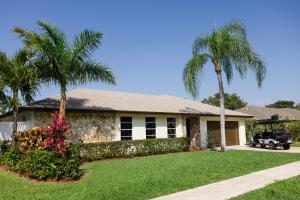 a house with two palm trees in a yard at Blu Sky Villa in Boynton Beach