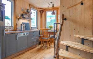 a kitchen and dining room in a log cabin at Haus Panoramablick in Lennestadt