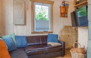 a living room with a brown leather couch and a television at Haus Panoramablick in Lennestadt