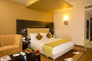 Postel nebo postele na pokoji v ubytování Poppys Hotel Madurai