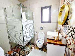 a bathroom with a shower and a toilet and a sink at "In the heart of Acre" from Shneider Apartments in Acre