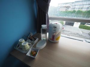 a table with a blender and containers of food on a window at Sleepwell@naiyang in Nai Yang Beach
