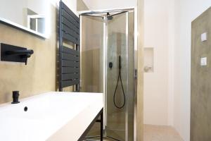 a shower with a glass door in a bathroom at Suite Guagnano Luxury apartment in Nardò