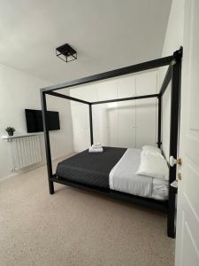 a bedroom with a bed with a black frame at Suite Guagnano Luxury apartment in Nardò