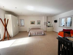 a bedroom with a bed and a tiled floor at Villa Eletti in Matera