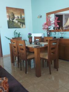 a wooden table and chairs in a room at Ulmus Suite in Volos