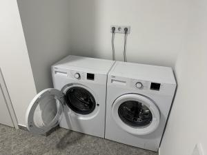 a washing machine and a washer in a room at irisHotels in Kyiv