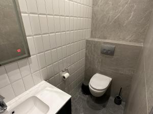 a bathroom with a white toilet and a sink at irisHotels in Kyiv