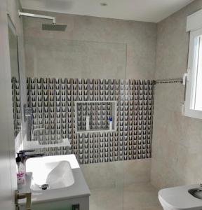 a bathroom with a sink and a shower at Casita moderna a escasos metros de Playa Terranova in Oliva