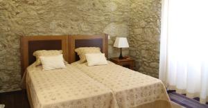 A bed or beds in a room at Quinta Anna Horvath