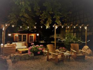 a patio with two chairs and a couch with lights at Boutique-Hotel Krone in Denzlingen