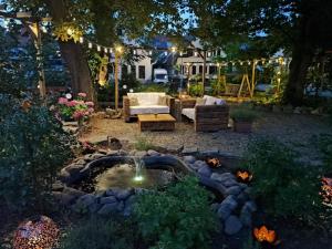 a backyard with a fountain and a fire pit at night at Boutique-Hotel Krone in Denzlingen