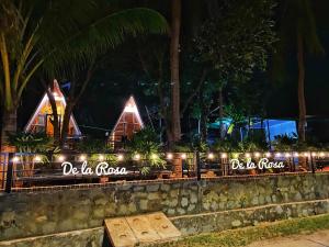 a resort with lights on a wall at night at Homestay De la Rosa - Côn Đảo in Con Dao