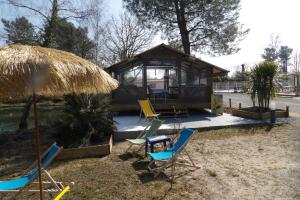 a group of chairs and a gazebo at Camping maeva Escapades Les Etangs Mina in Saint-Sornin