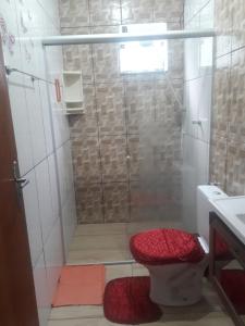 a bathroom with a shower with a toilet and a sink at Recanto do Sossego in Alto Caparao +32 photos