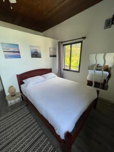 a bedroom with a large bed and a window at Baia Seixal Oceanfront in Seixal