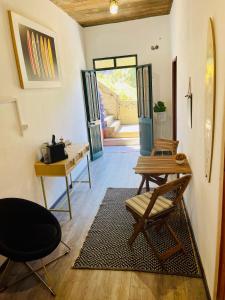 a room with a table and a chair and a door at Baia Seixal Oceanfront in Seixal