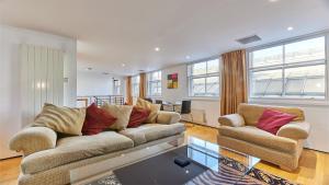a living room with a couch and two chairs at The Monument in Newcastle upon Tyne