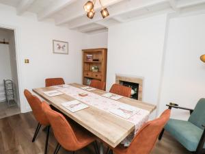 a dining room with a wooden table and chairs at Braeside in Whitby