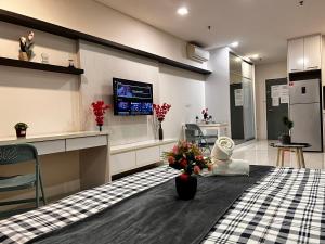 a living room with a table with flowers on it at Mercu Summer Suites KLCC by SS Residence in Kuala Lumpur