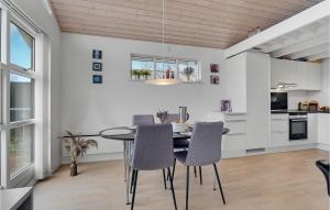 a kitchen and dining room with a table and chairs at 3 Bedroom Amazing Home In Mariager in Mariager