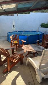 a group of chairs and a picnic table and a pool table at Colinas in Ciudad de la Costa