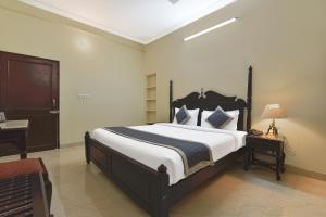 a bedroom with a large bed and a desk at Noble House - A Heritage Home in Jaipur